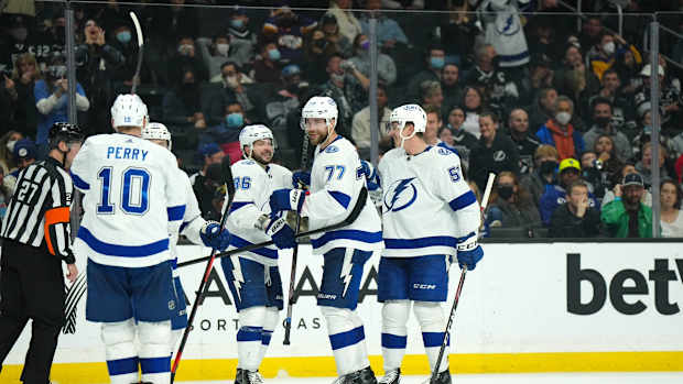 Jan 18, 2022; Los Angeles, California, USA; Tampa Bay Lightning defenseman Victor Hedman (77) celebrates with right wing Corey Perry (10) and right wing Nikita Kucherov (86) and defenseman Cal Foote (52) after scoring a goal against the LA Kings in the third period at Crypto.com Arena. Mandatory Credit: Kirby Lee-USA TODAY Sports